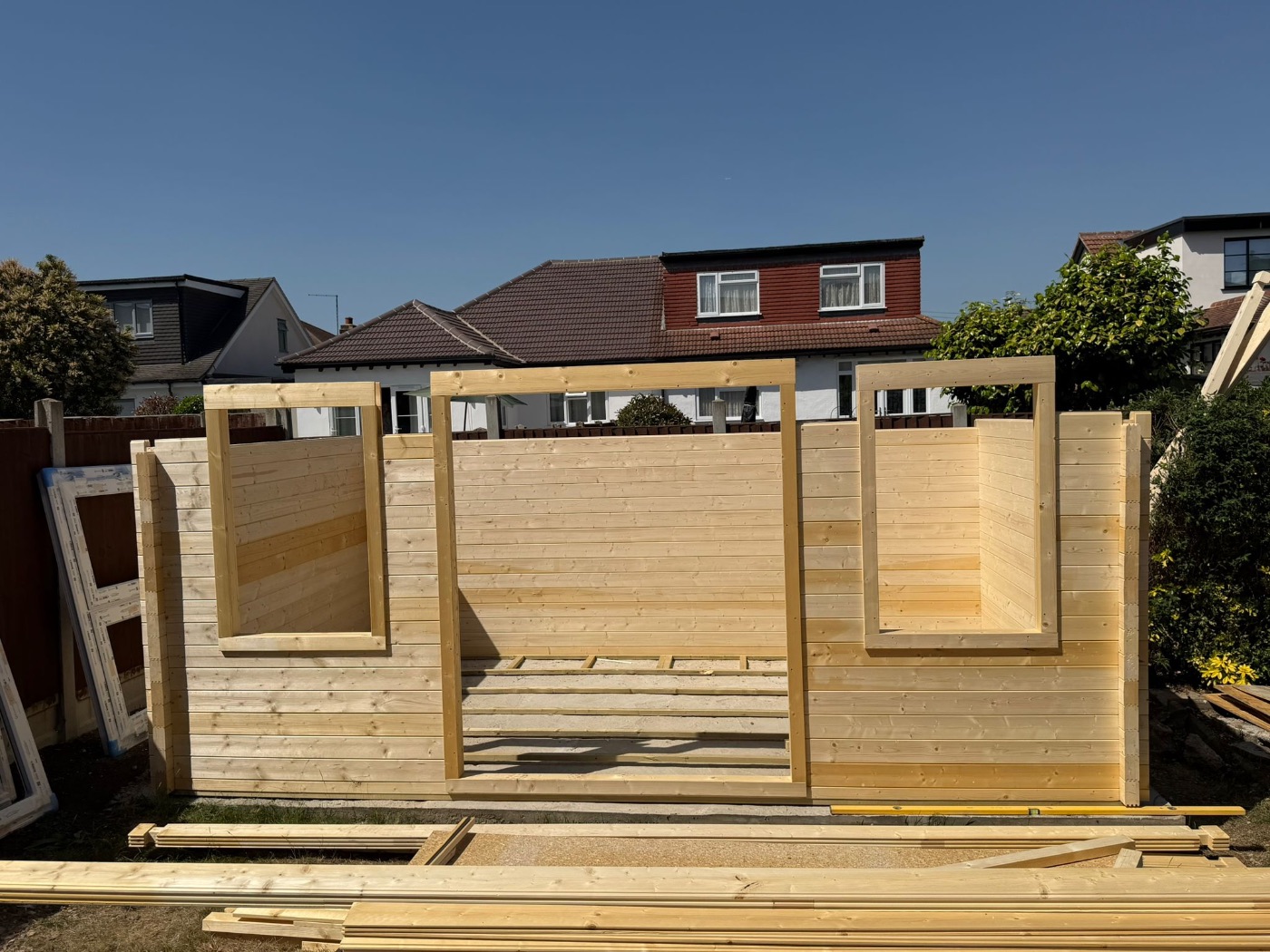 Front elevation of the timber building with door and window openings framed